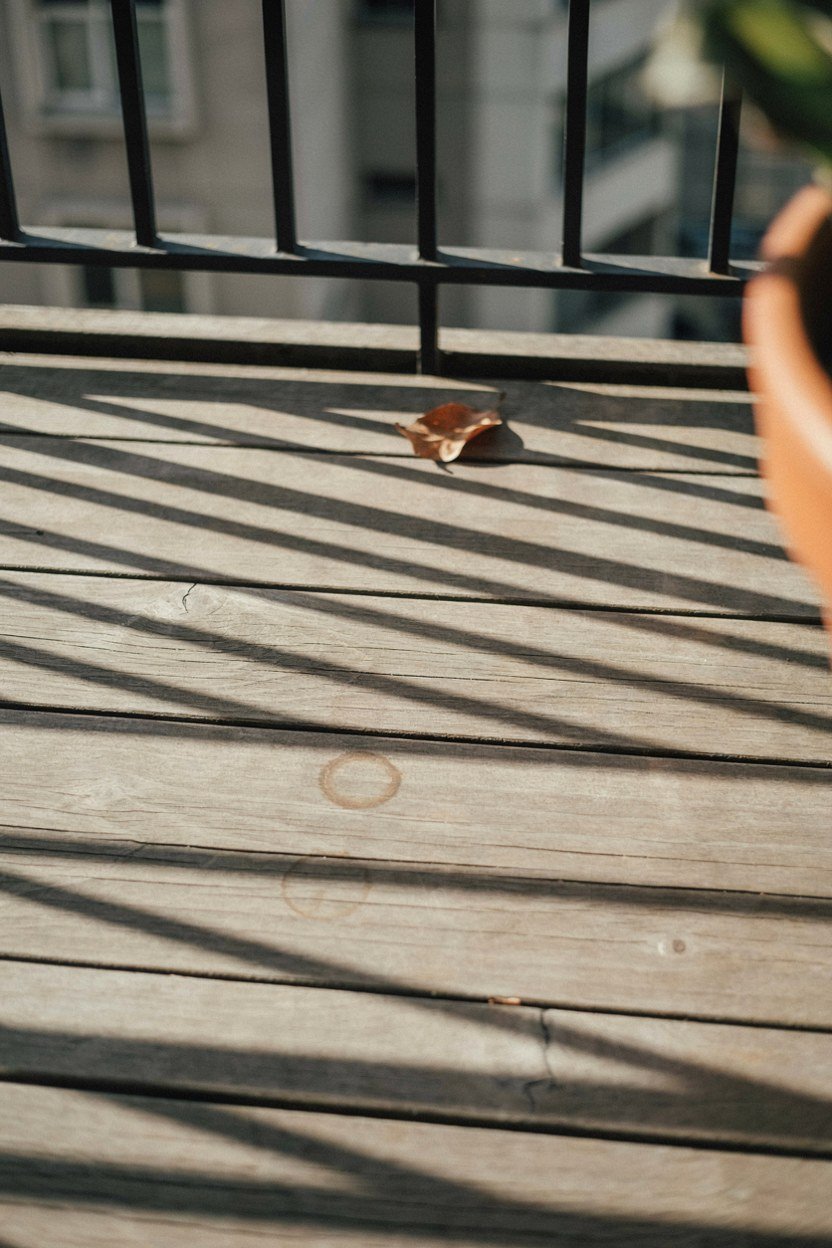 Sunlight falling across an empty balcony floor