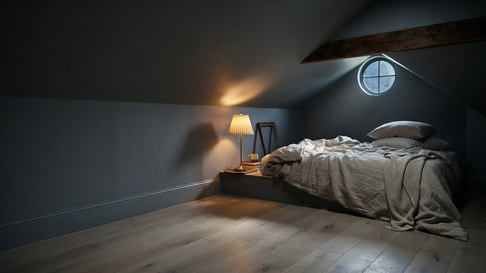 Charcoal gray attic bedroom with sloped ceiling and low bed