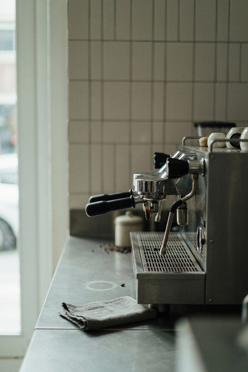Coffee station counter at working height with clear surface beside the machine