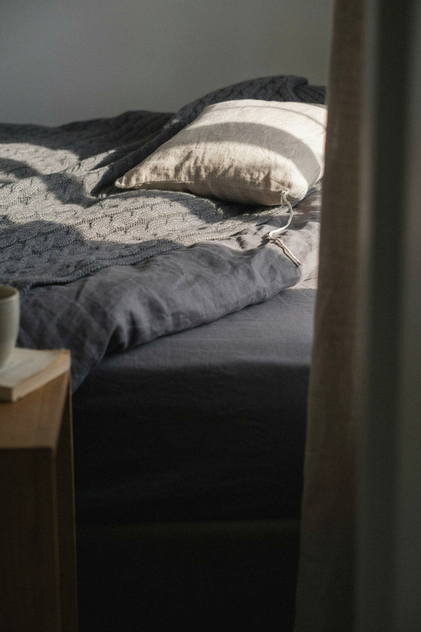 Bedding layered in three tones of charcoal and grey