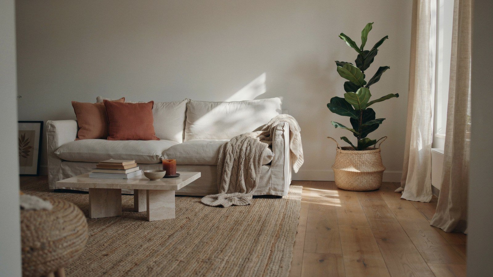 Modern boho living room layered in neutral textures with a large jute rug
