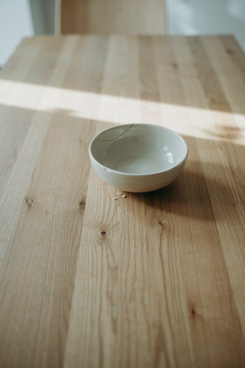 One low bowl placed off centre on a bare dining table