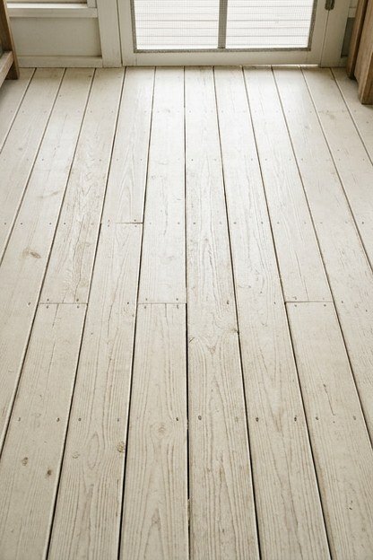 A whitewashed timber porch floor showing the natural grain through the finish